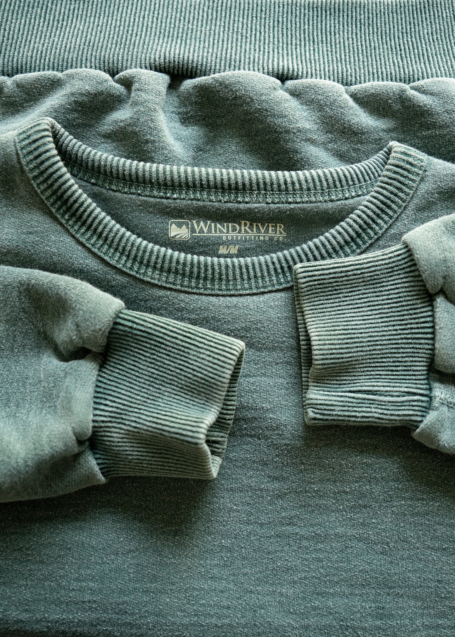 Green fleece crewneck sweatshirt with 'Wind River' label