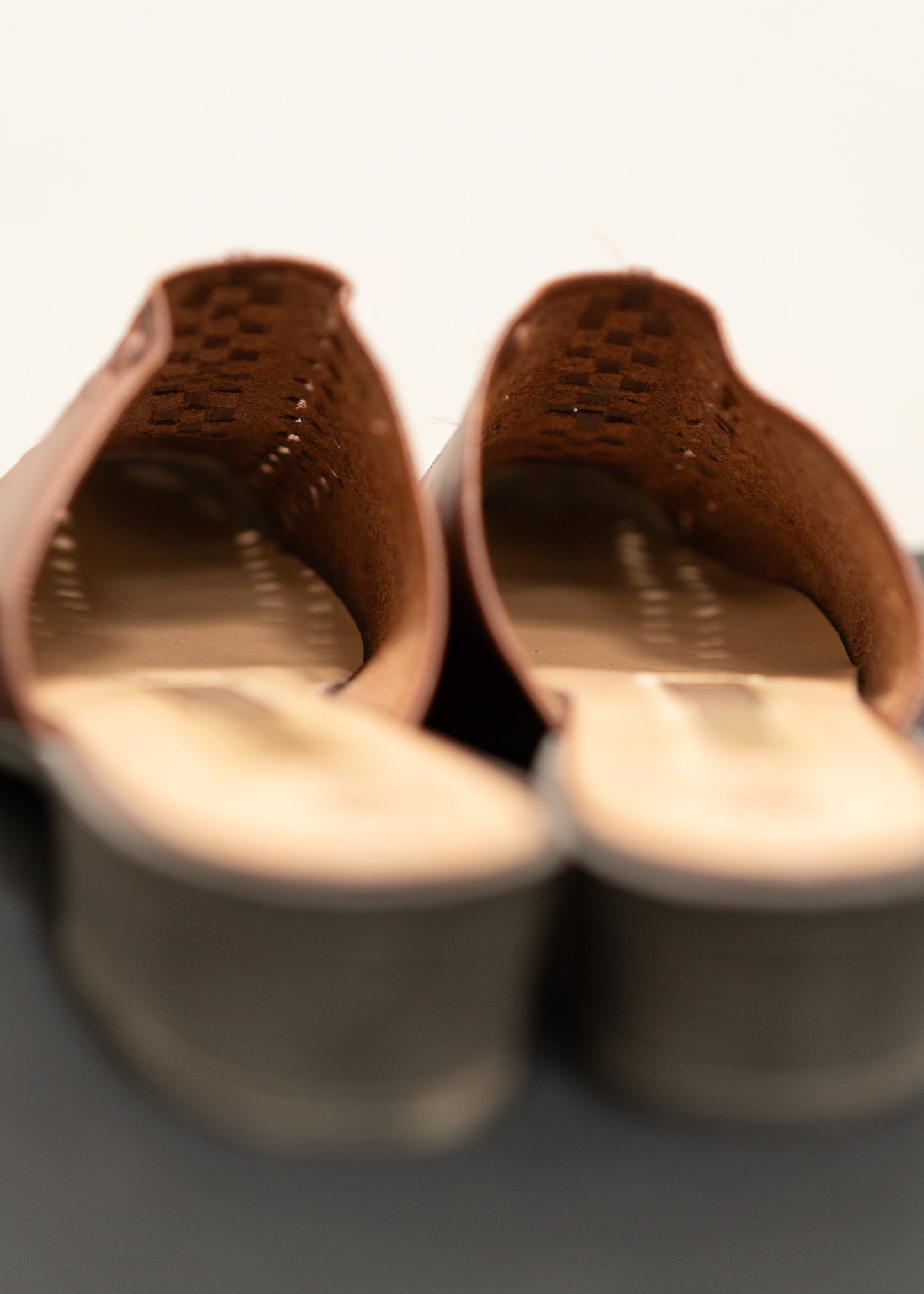 Pair of brown leather shoes with a blurred background