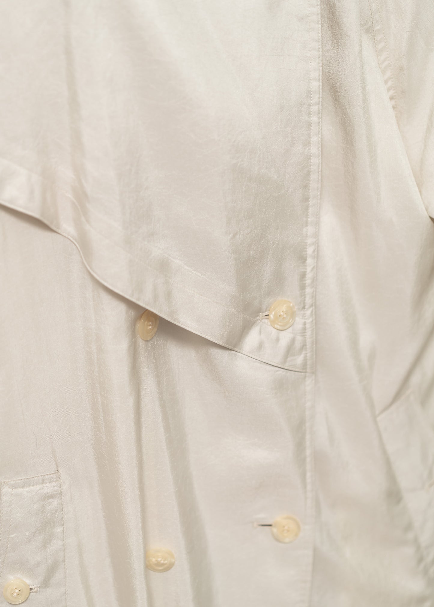 detail shot of a cream trench coat