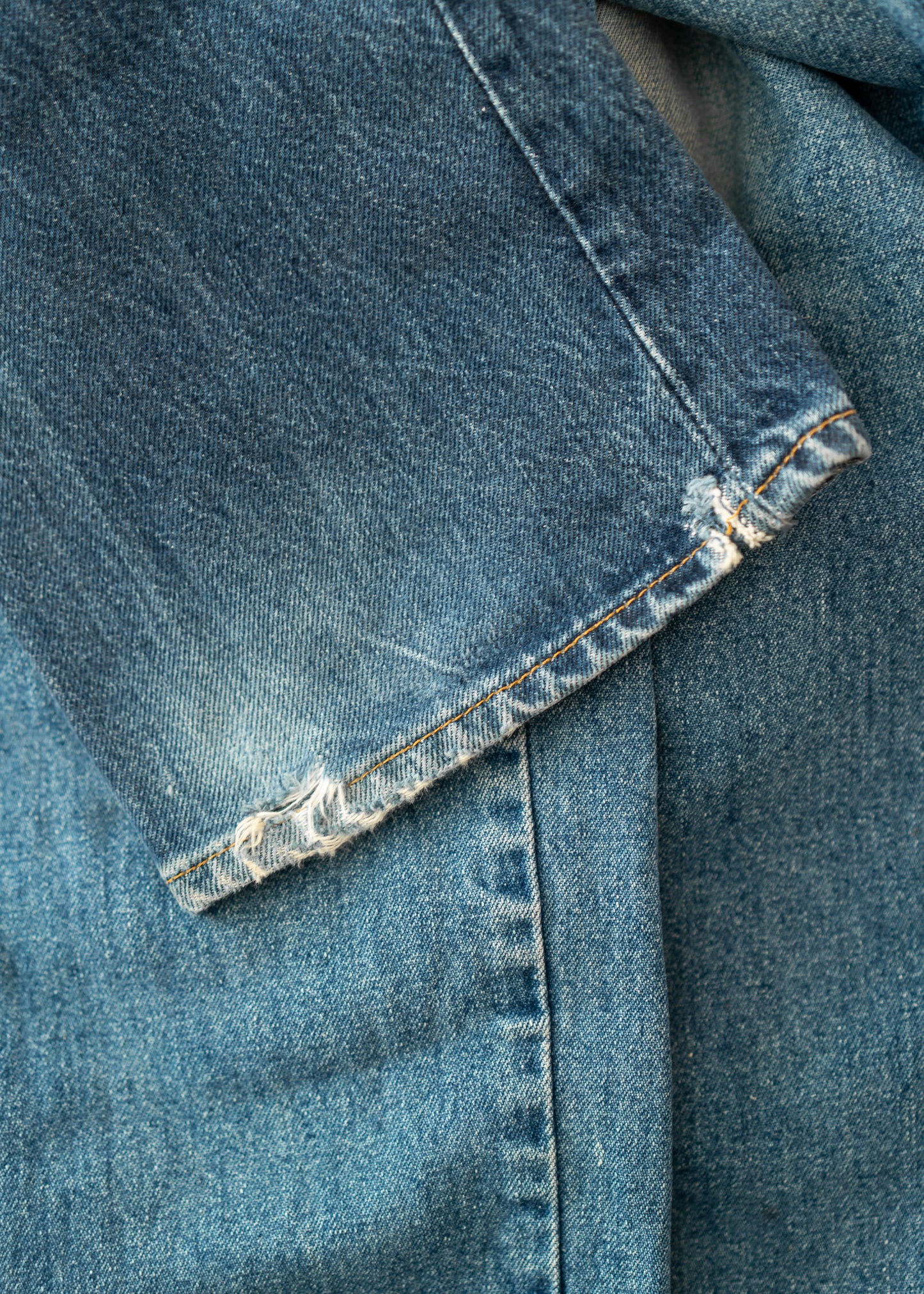 close up of vintage blue jeans with hem