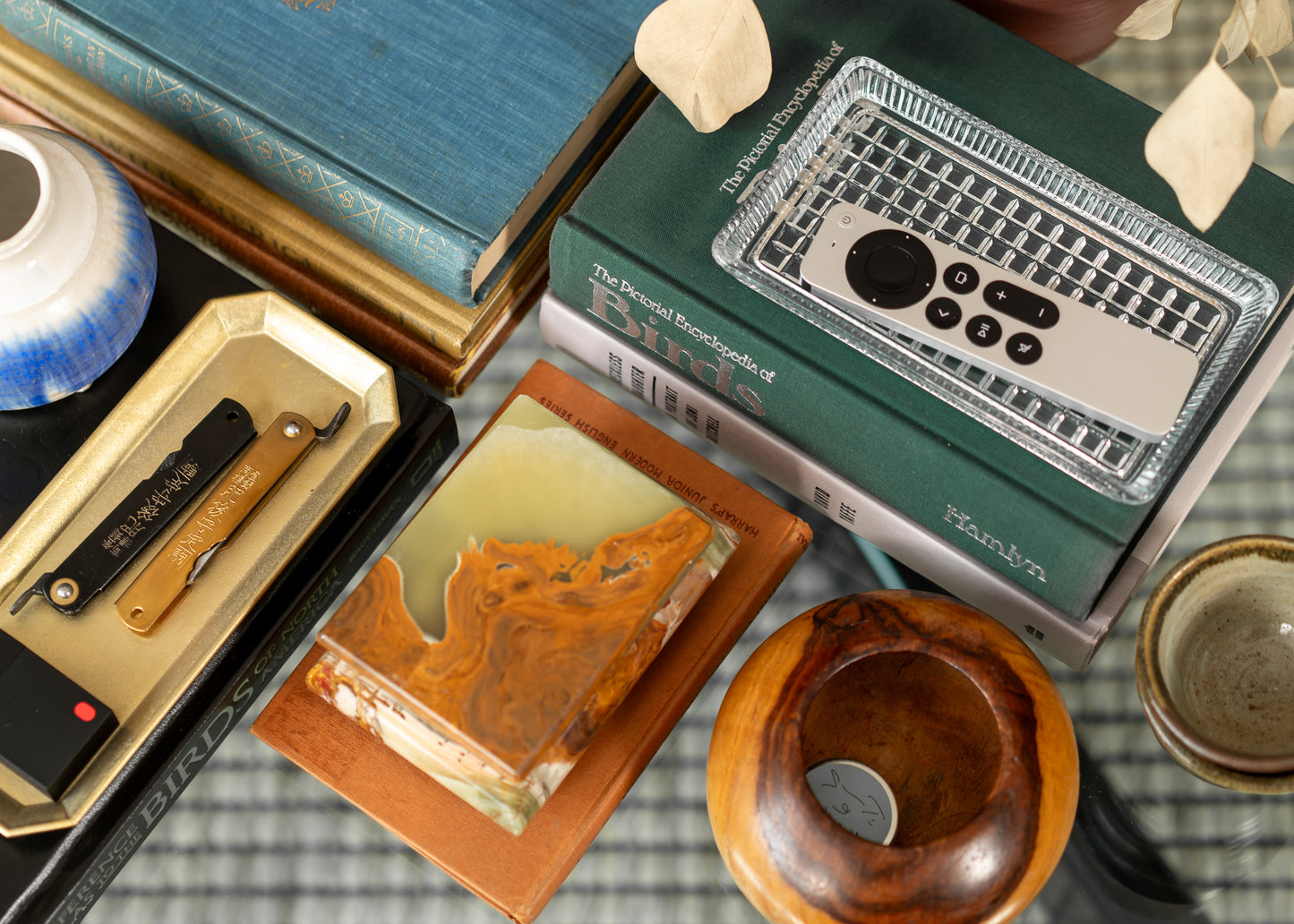 Collection of vintage onyx box and vintage books on a checkered surface