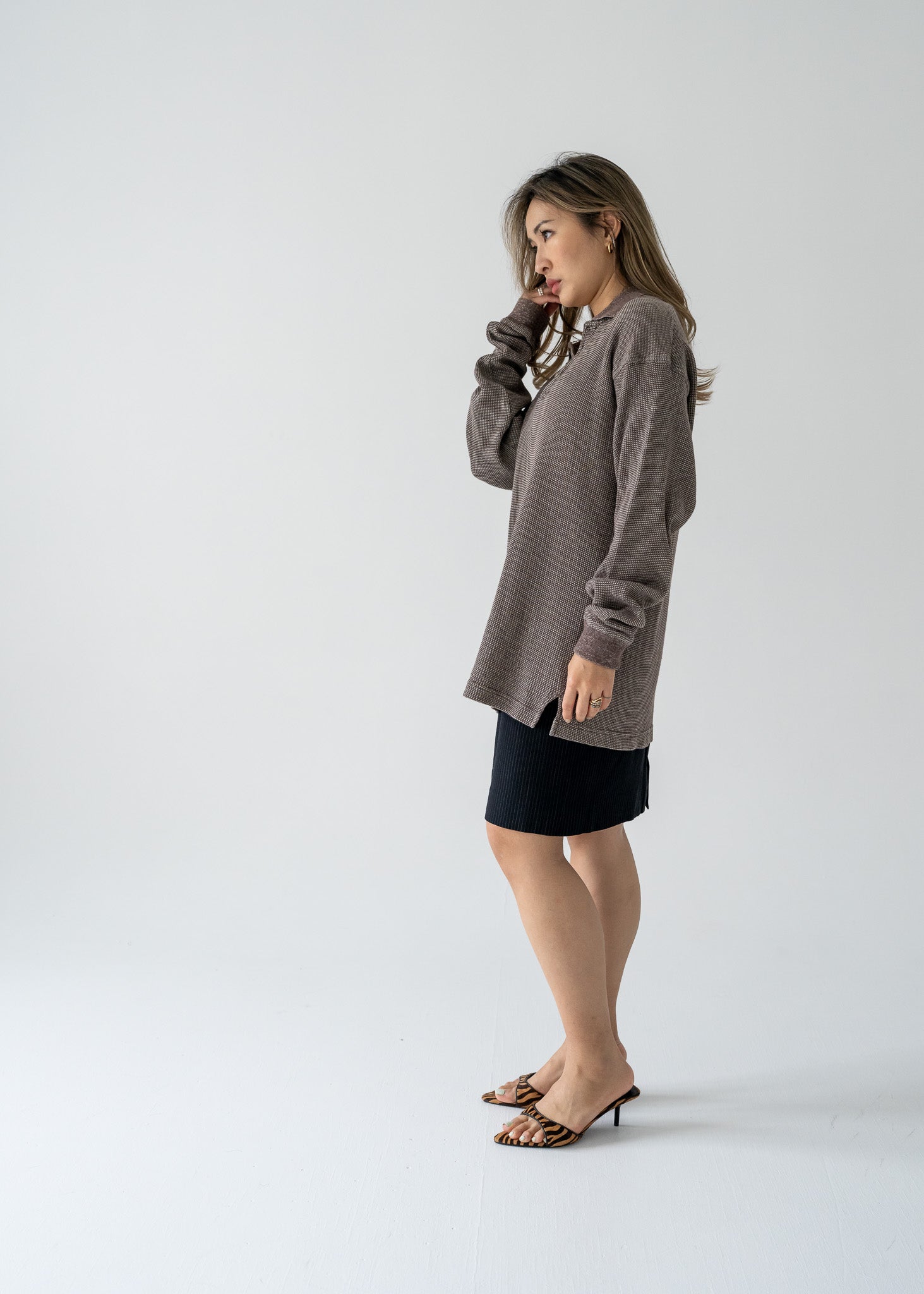 woman wearing a vintage brown long sleeve collared waffle knit shirt and black skirt