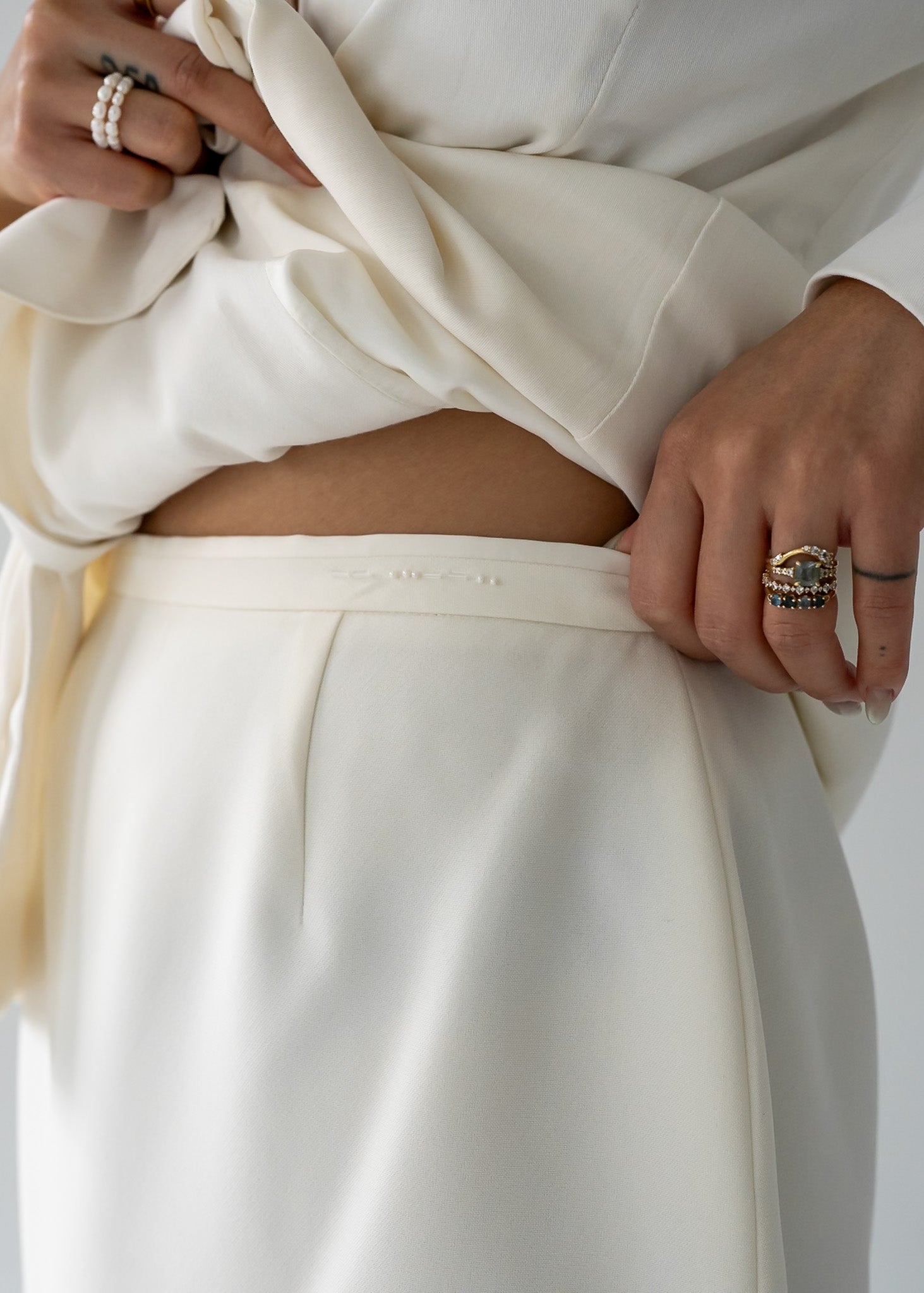 detail shot of vintage cream long line skirt with a centre back slit and a dainty beaded band.