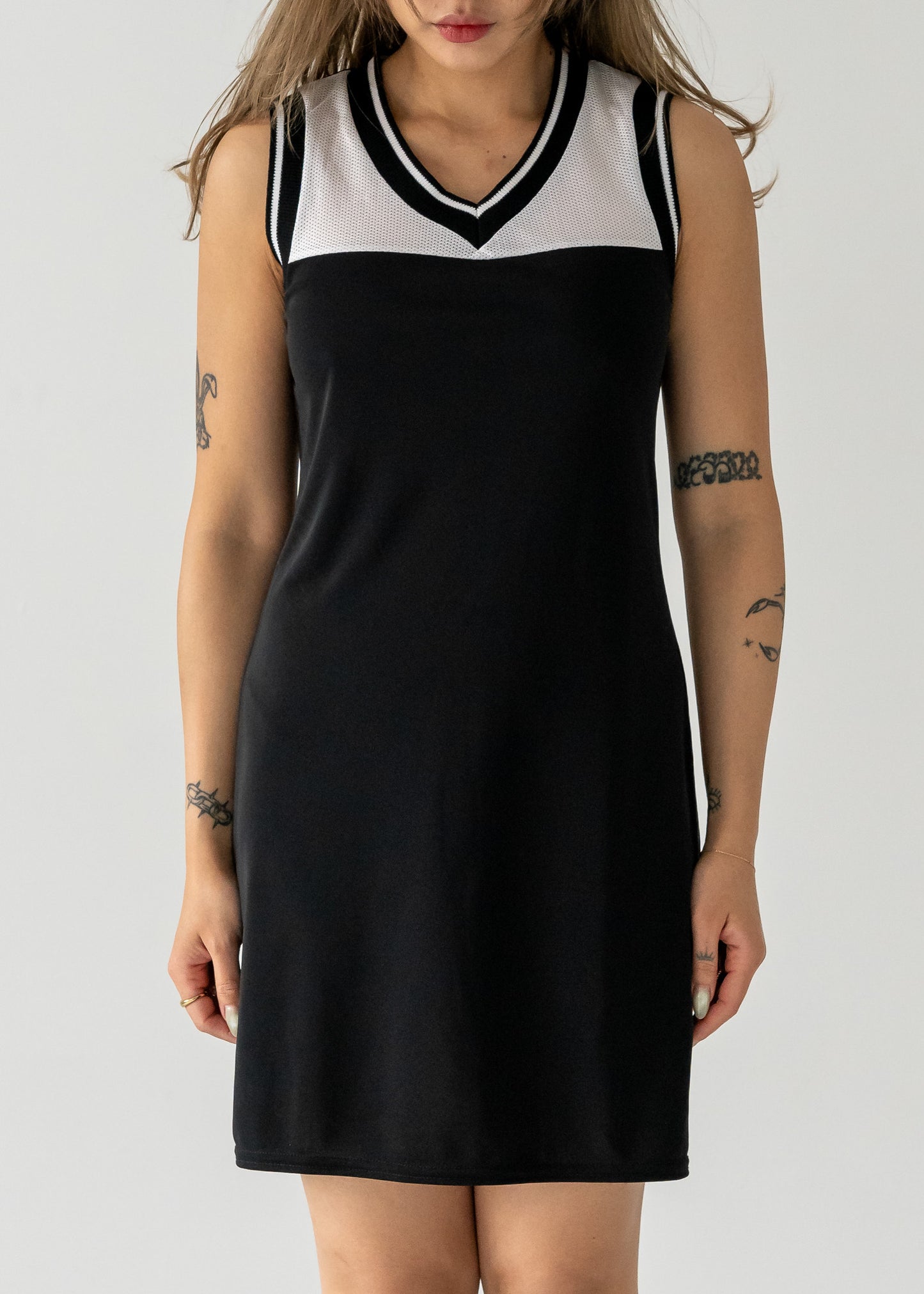 black and white mesh vintage 90's sporty tank dress with a rounded v neck worn by a person on a plain background