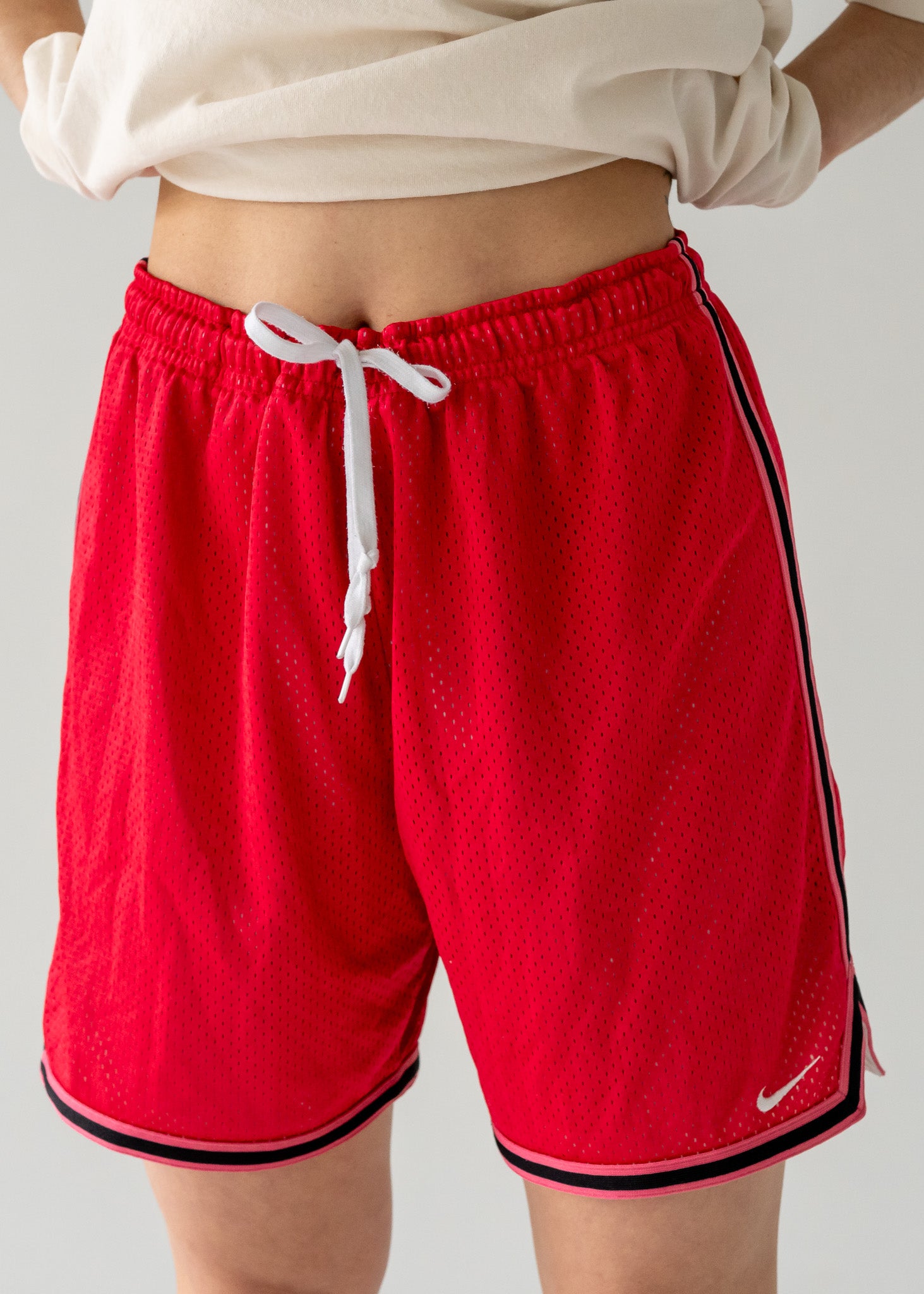 vintage red athletic shorts with white drawstring and black trim.