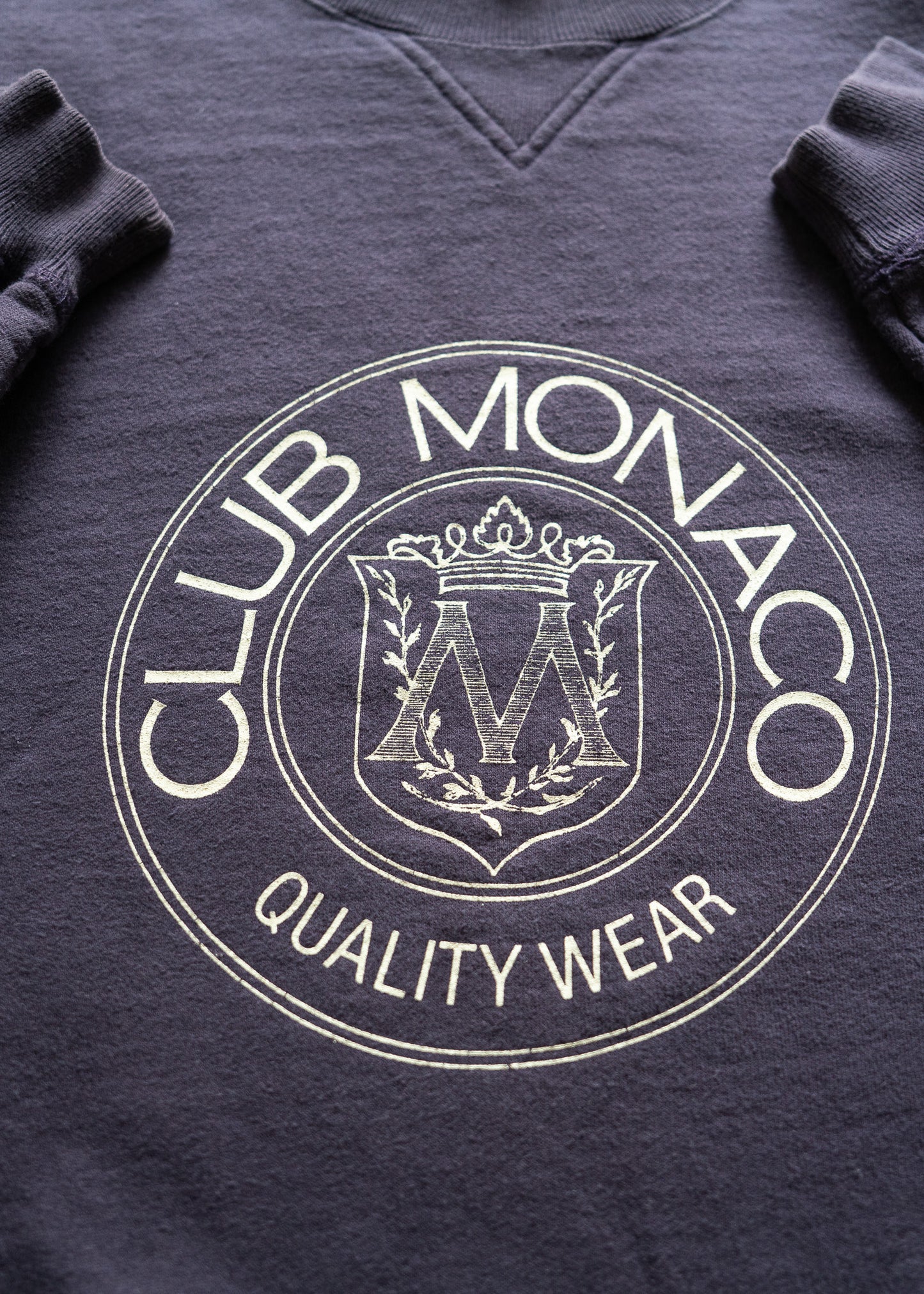 dark purple sweatshirt with Club Monaco logo and text