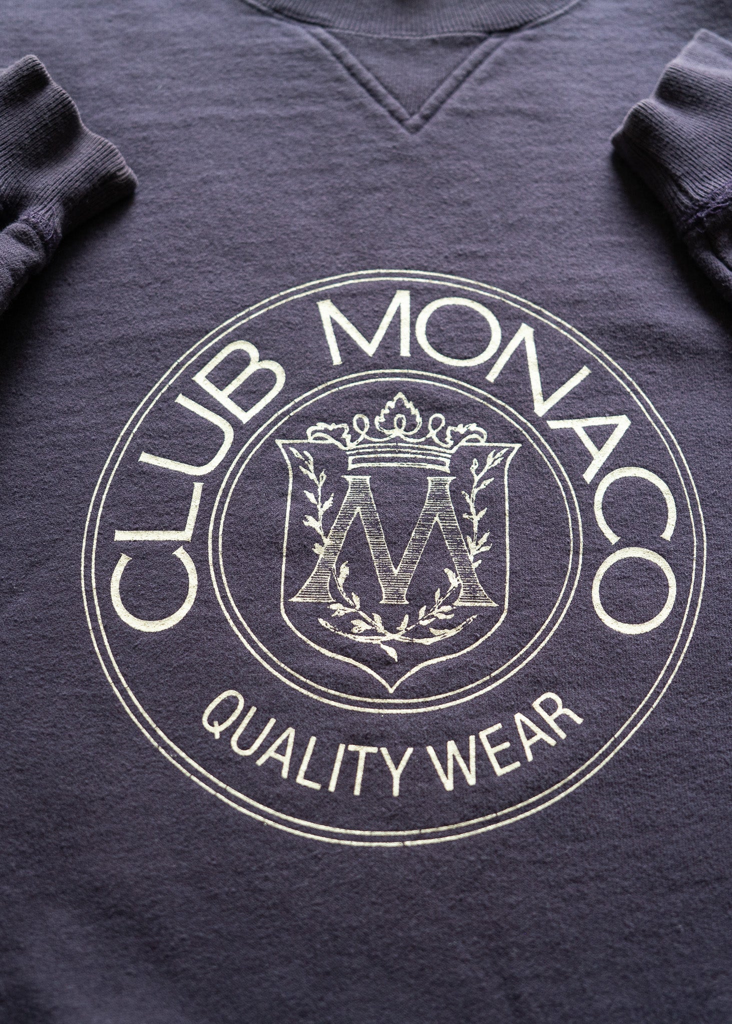 dark purple sweatshirt with Club Monaco logo and text