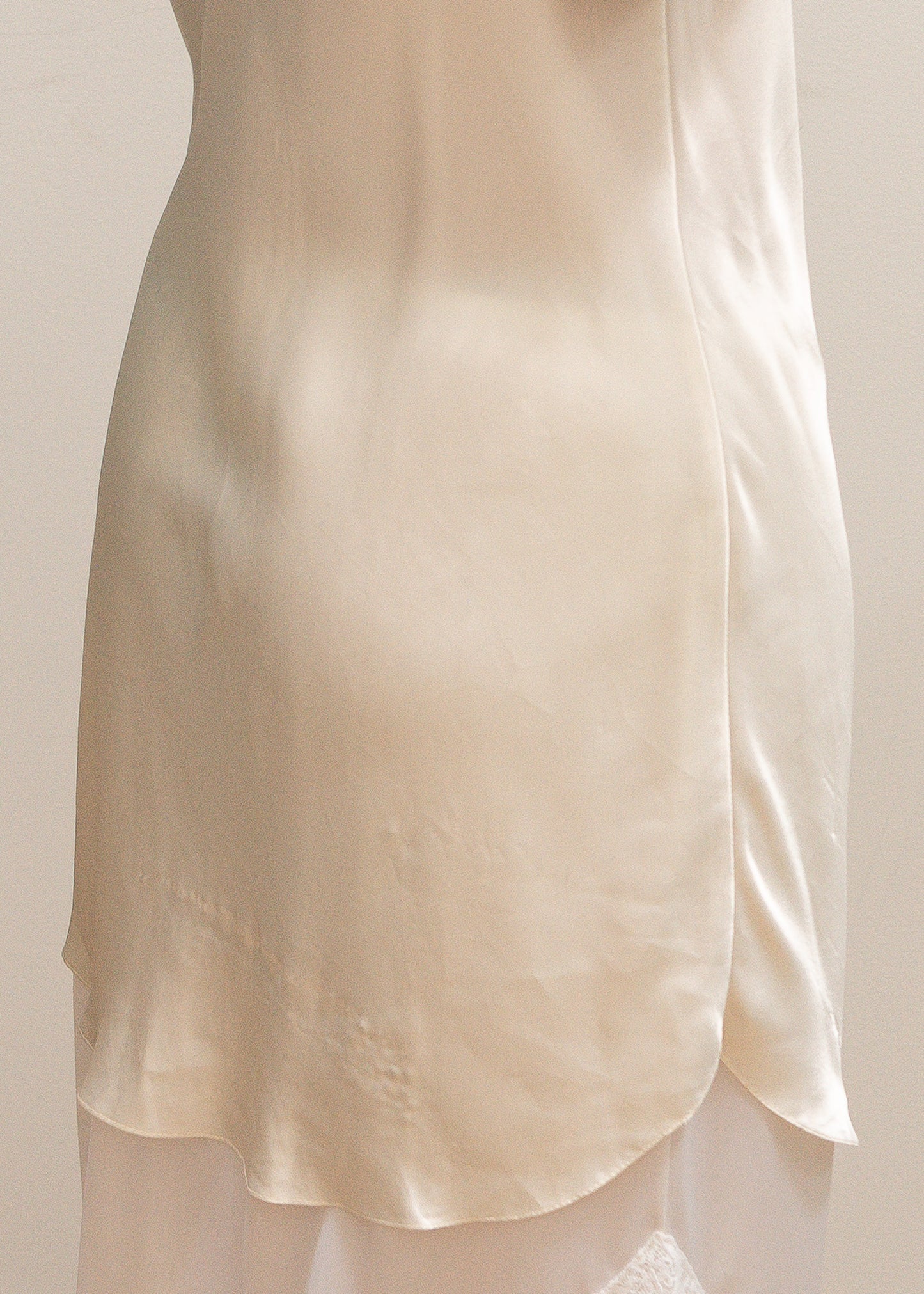 ivory satin slip and lace skirt against a plain background