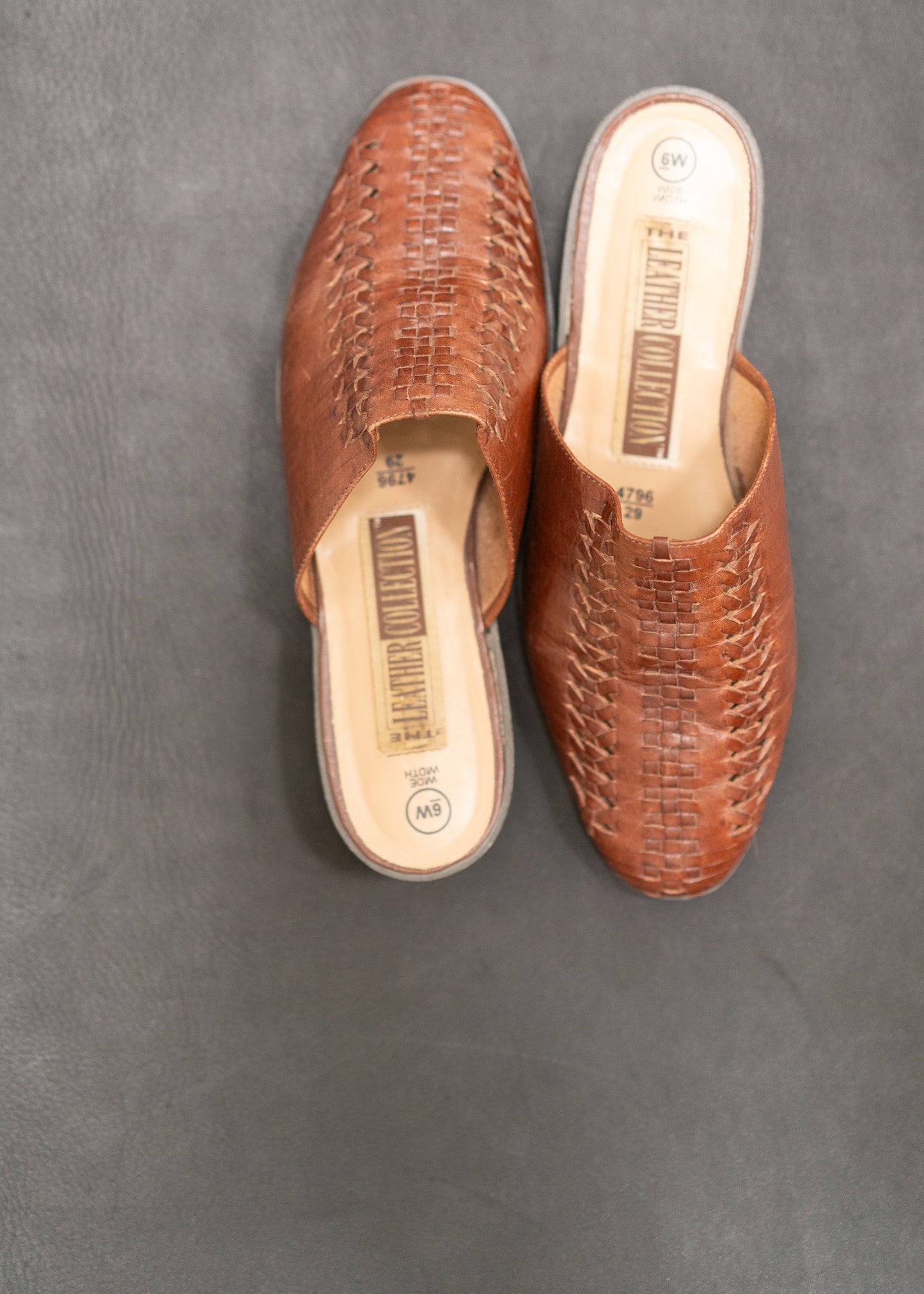Pair of brown woven shoes on a gray background