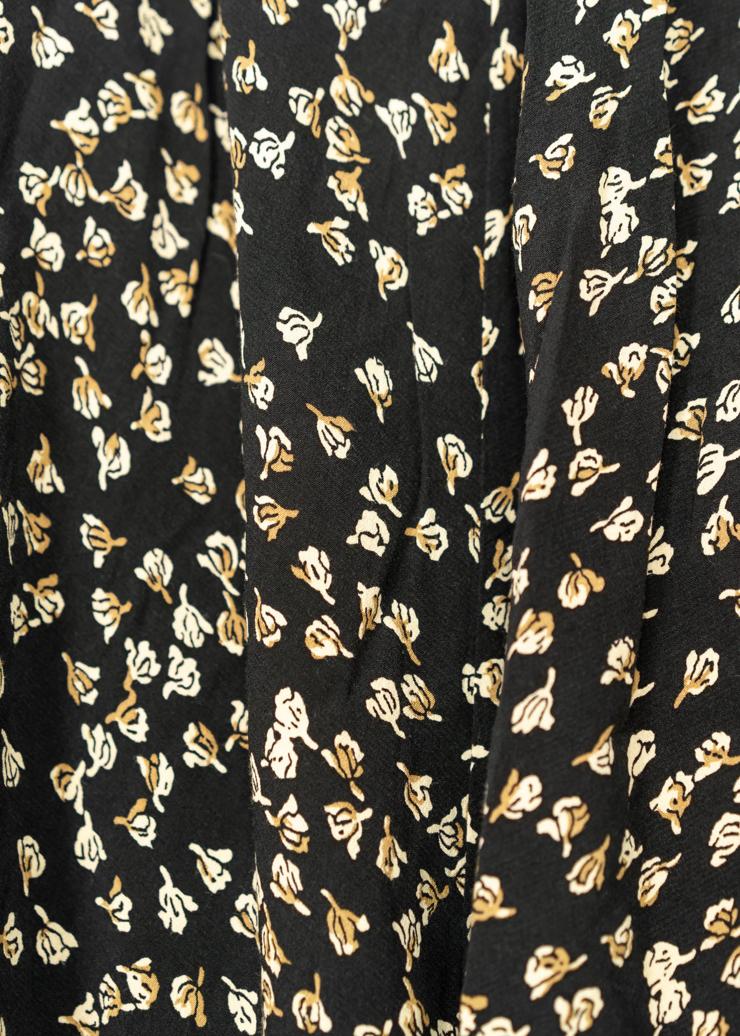 Close-up of black fabric with gold floral pattern