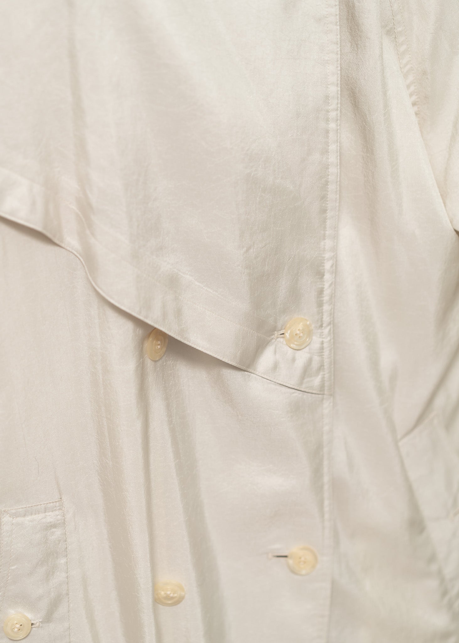 detail shot of a cream trench coat