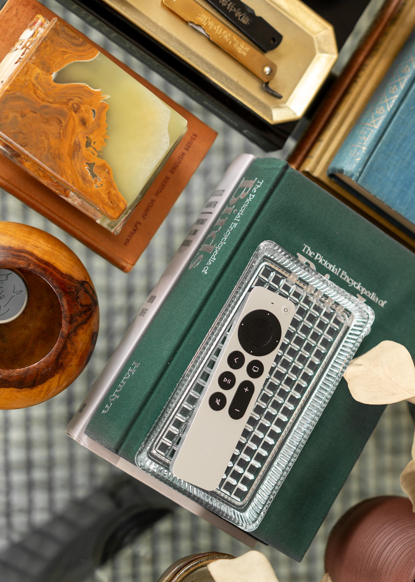 Collection of vintage books and wooden items on a textured surface