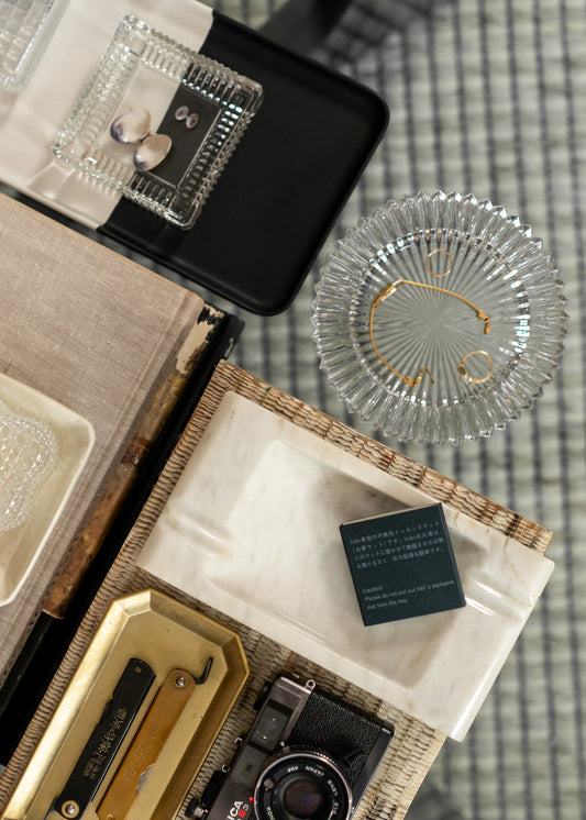 Vintage camera and vintage glass bowls on a textured surface