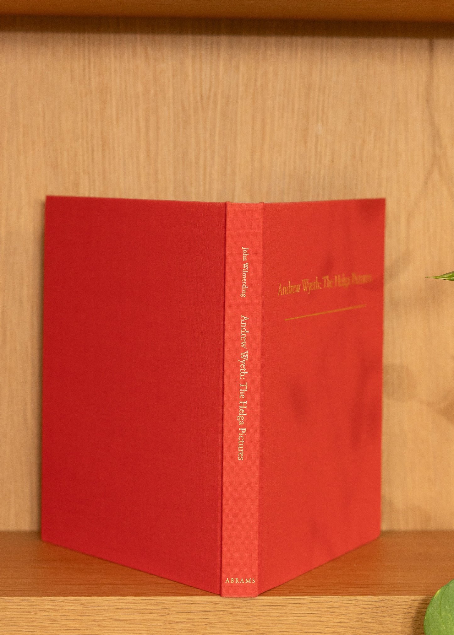 vintage red book with gold text on a wooden surface