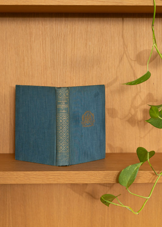 vintage blue book with decorative spine on a wooden shelf