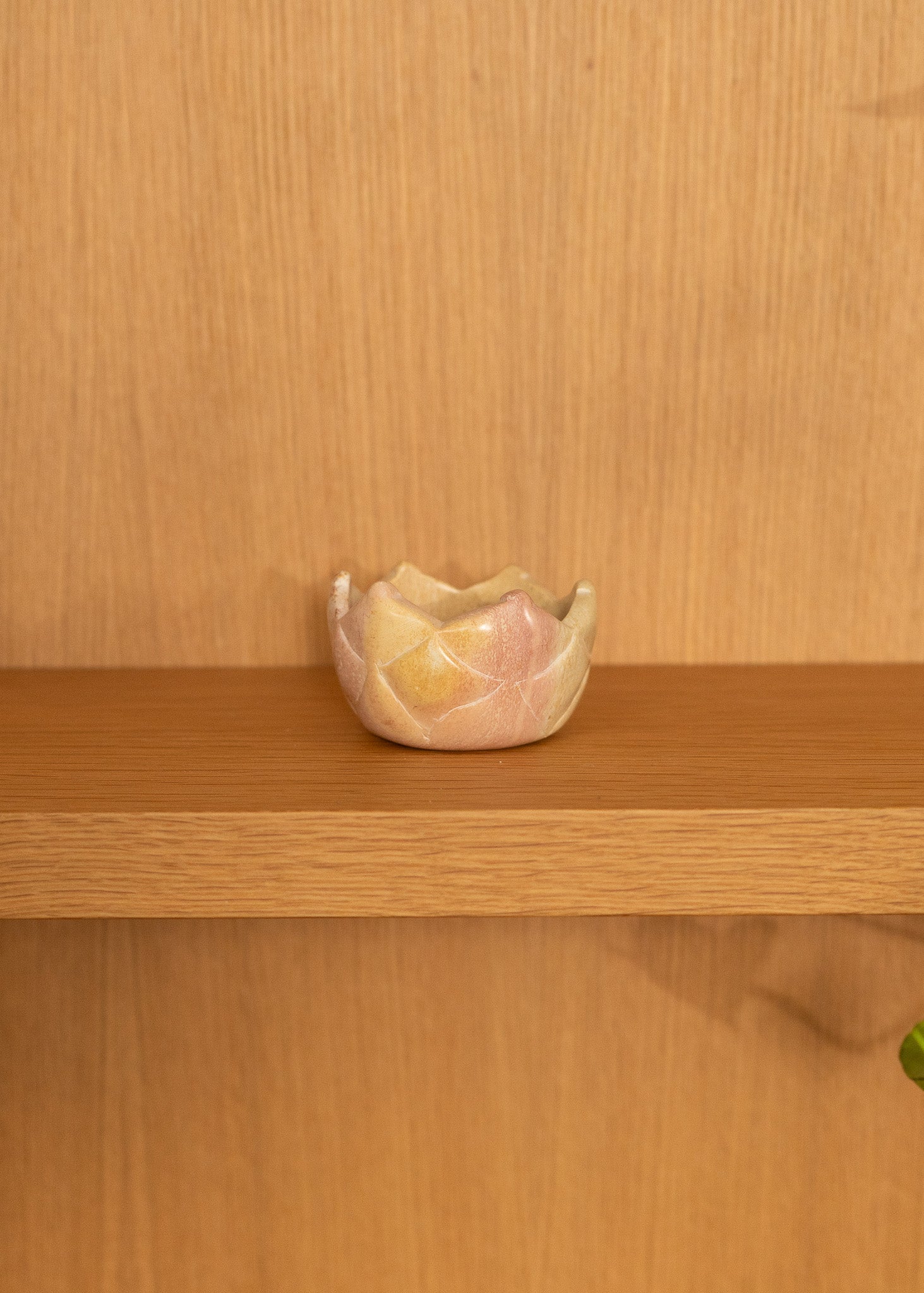 Small vintage stone bowl  on a wooden shelf