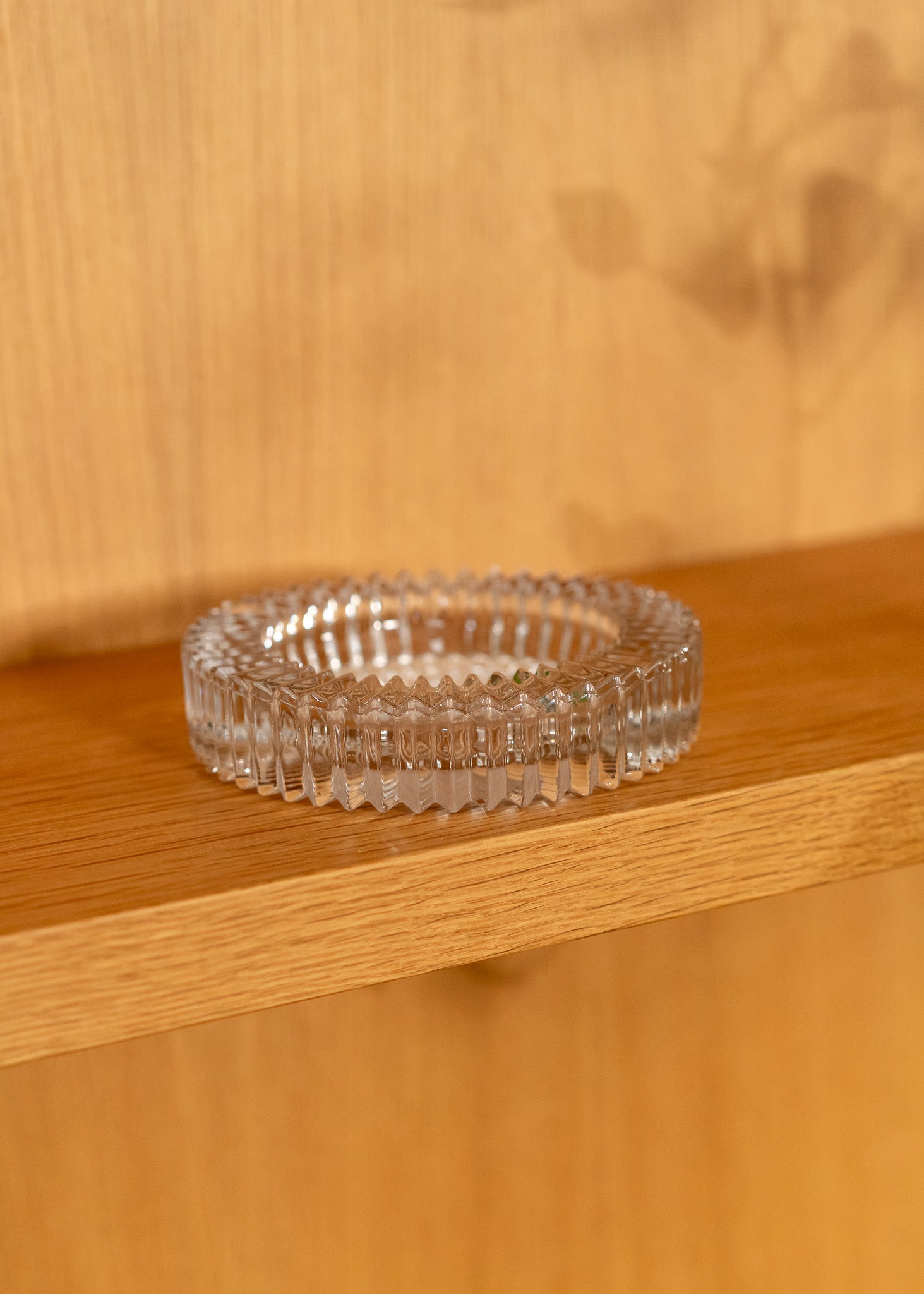 Clear vintage glass bowl on a wooden surface