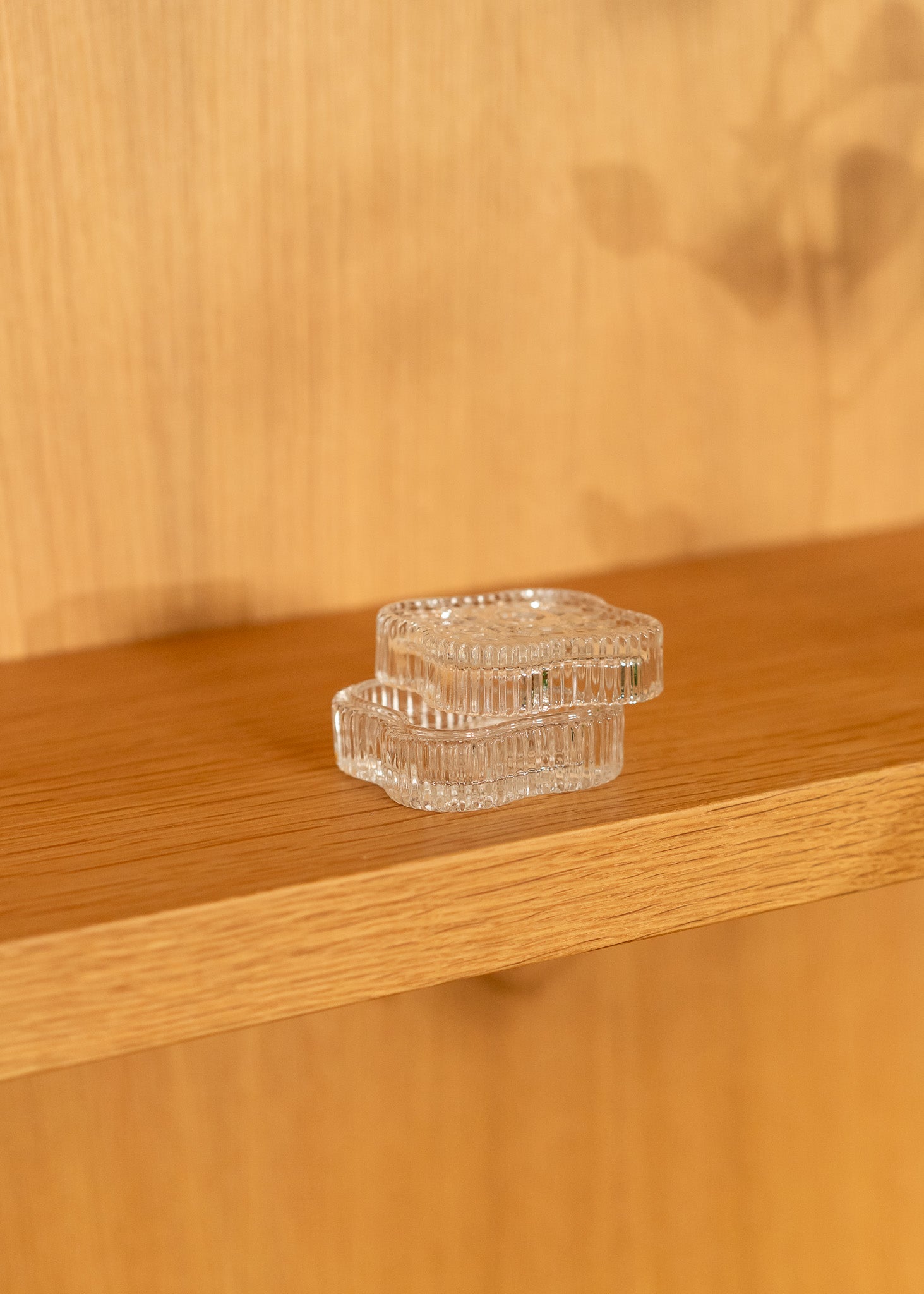 vintage clear glass lid and container on a wooden surface