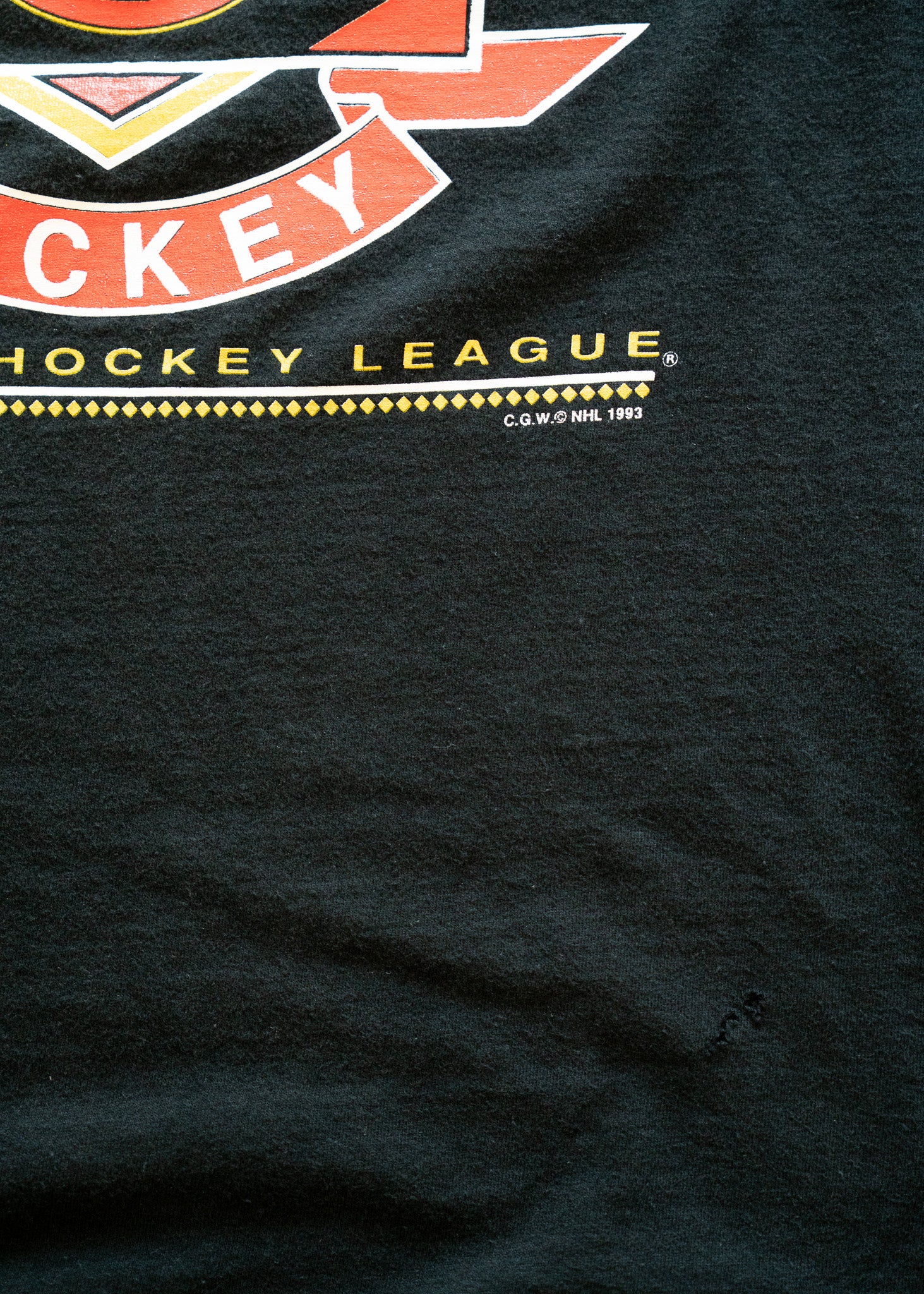 Black t-shirt with hockey league logo and text